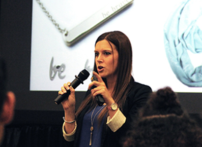 Stephanie Fox speaking at an event as CEO of Bravelets.